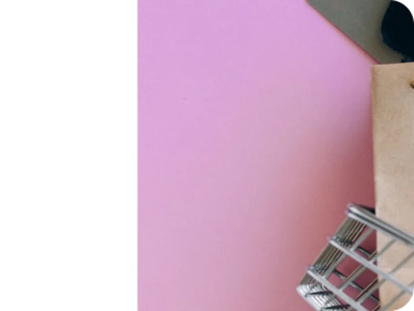 Shopping cart against a pink background